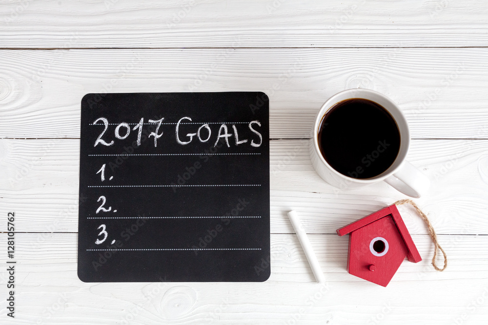 notebook and goals for new year wooden background top view