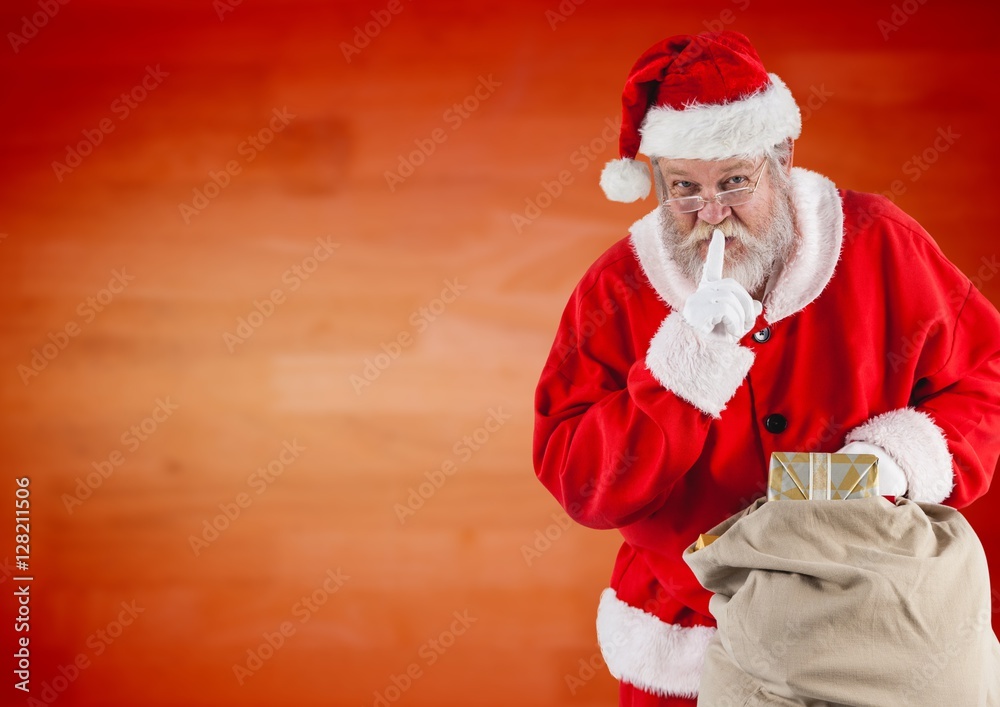 Santa claus holding gift sack with finger on lip