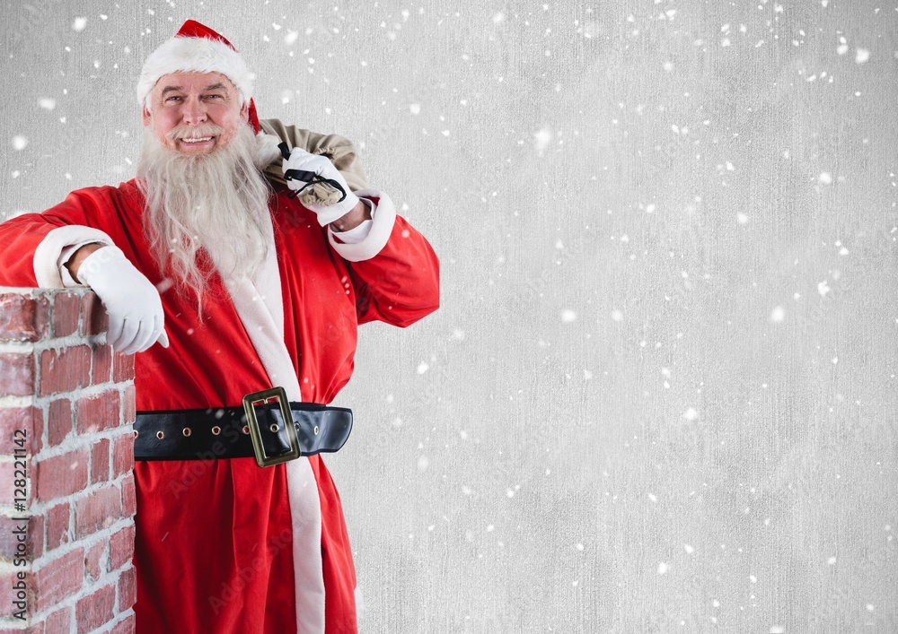 Happy santa with gift sack standing beside chimney