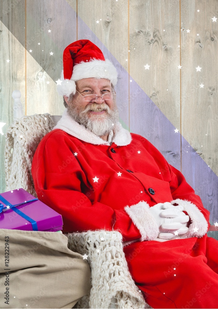 Smiling santa claus sitting with gift sack