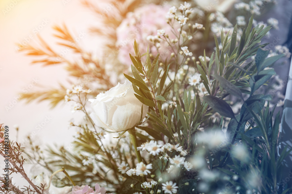 Beautiful spring flowers in a glass vase background of wedding p