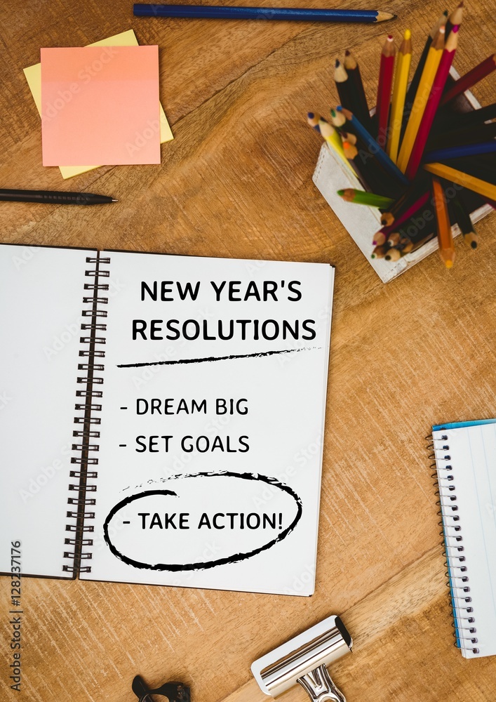 New year resolution goals with office supplies on wooden table