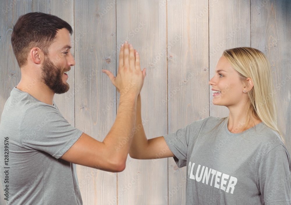 Volunteer couple in tshirt giving high five to each other