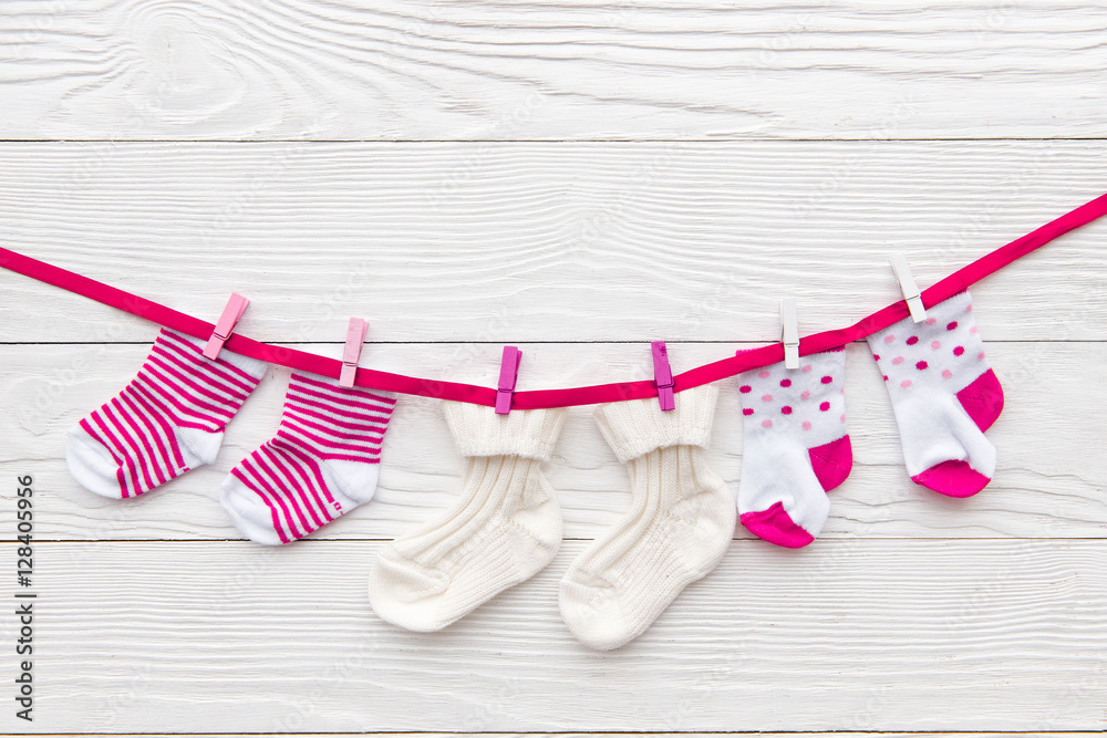 baby socks on rope at wooden background