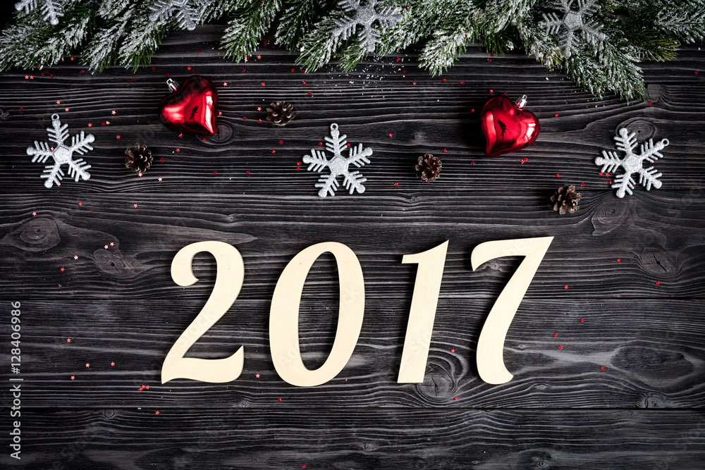 Christmas decorations, spruce branches on dark wooden background top view