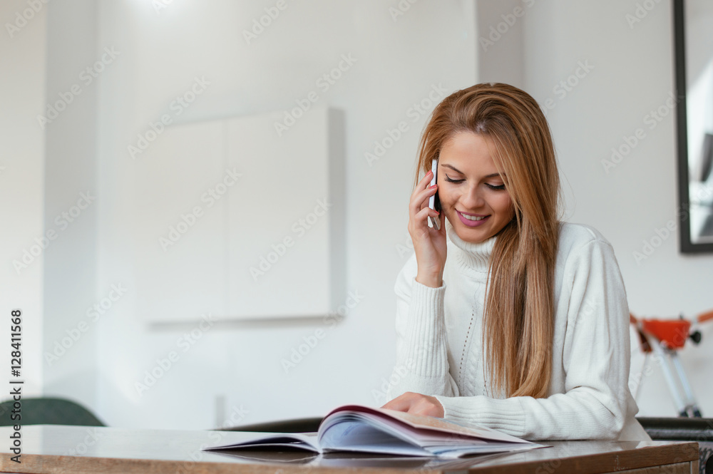 Carefree talk with friend. Cheerful young woman talking on phone