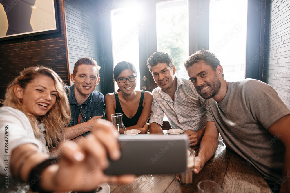 Small group of friends taking selfie on a mobile phone