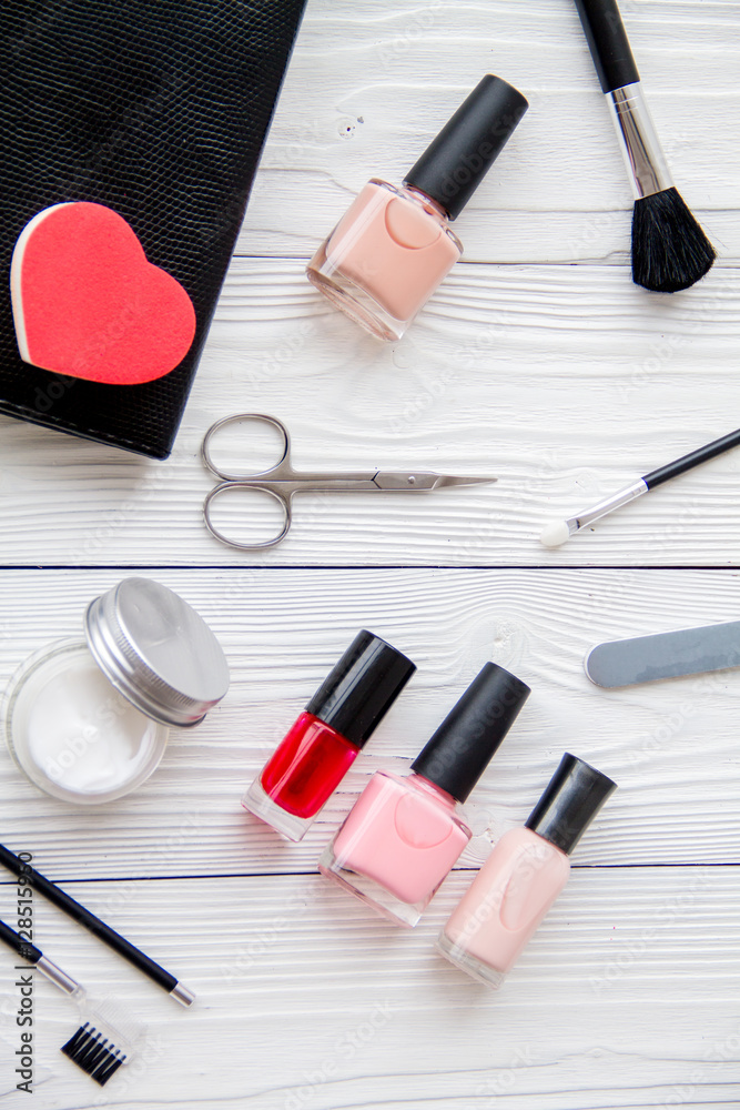 manicure set and nail polish on wooden background