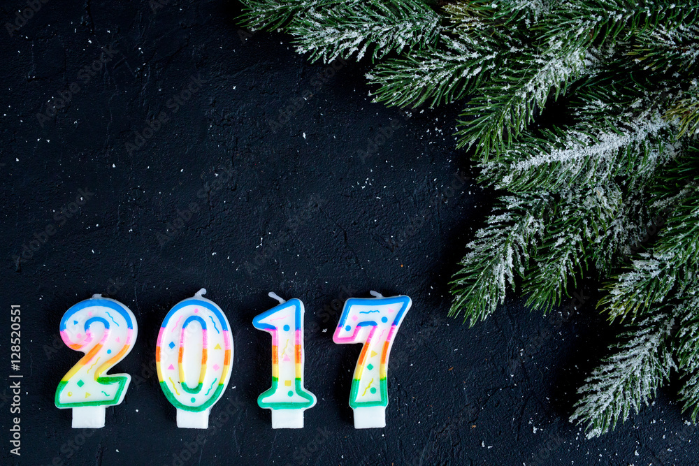 Christmas decorations, spruce branches on dark background top view