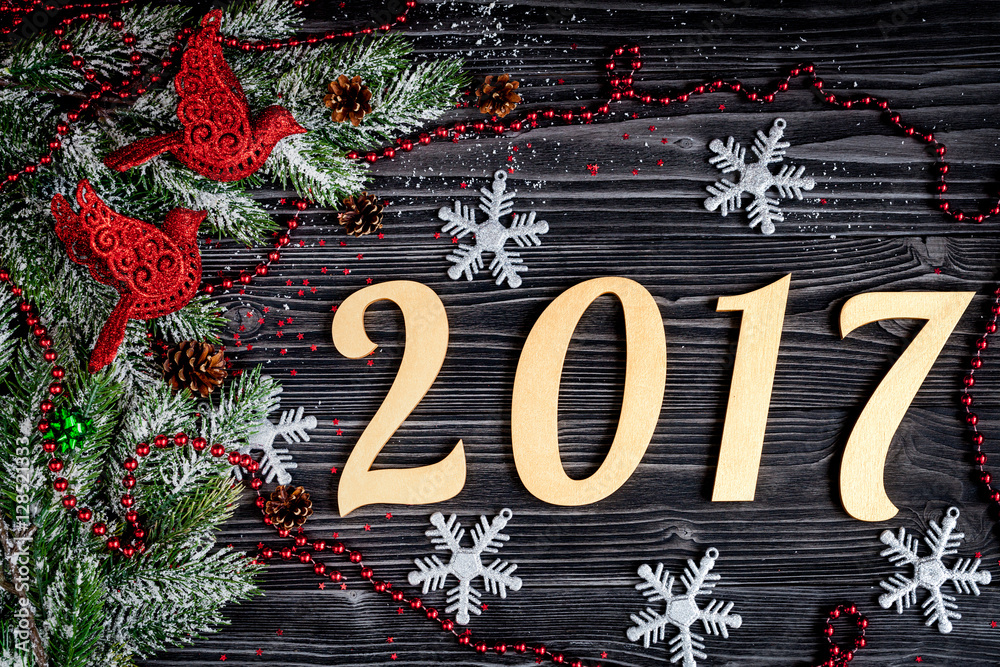 Christmas decorations, spruce branches on dark wooden background top view