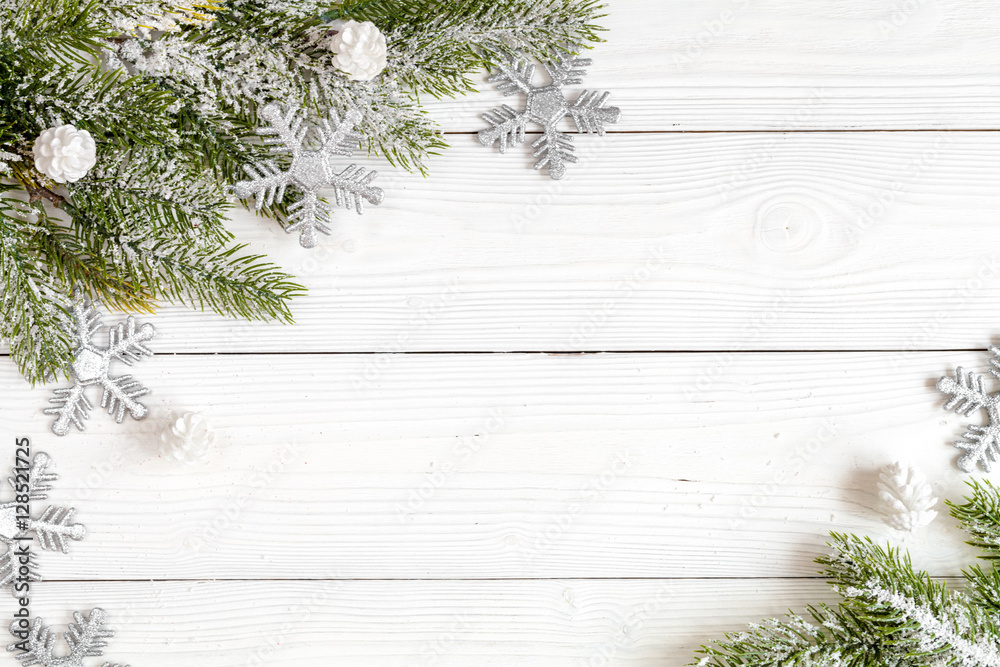 Christmas toys and spruce branches on wooden background top view