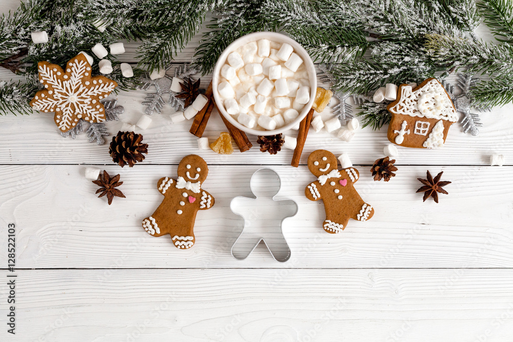 Christmas gingerbread, spruce branches on wooden background top view