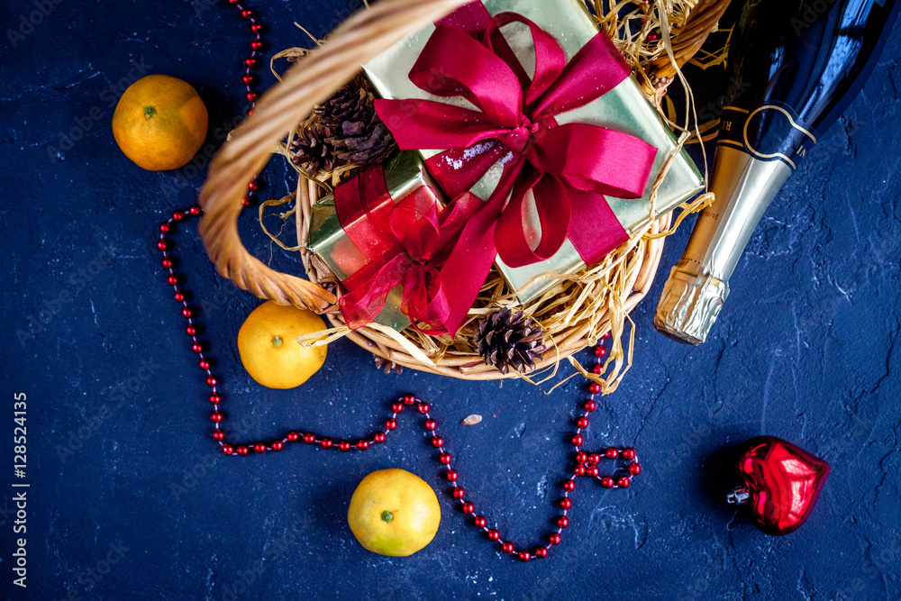 Christmas gifts and champagne with tangerines top view