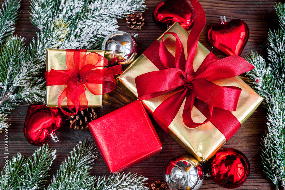 gifts boxes with fir branches on wooden background top view