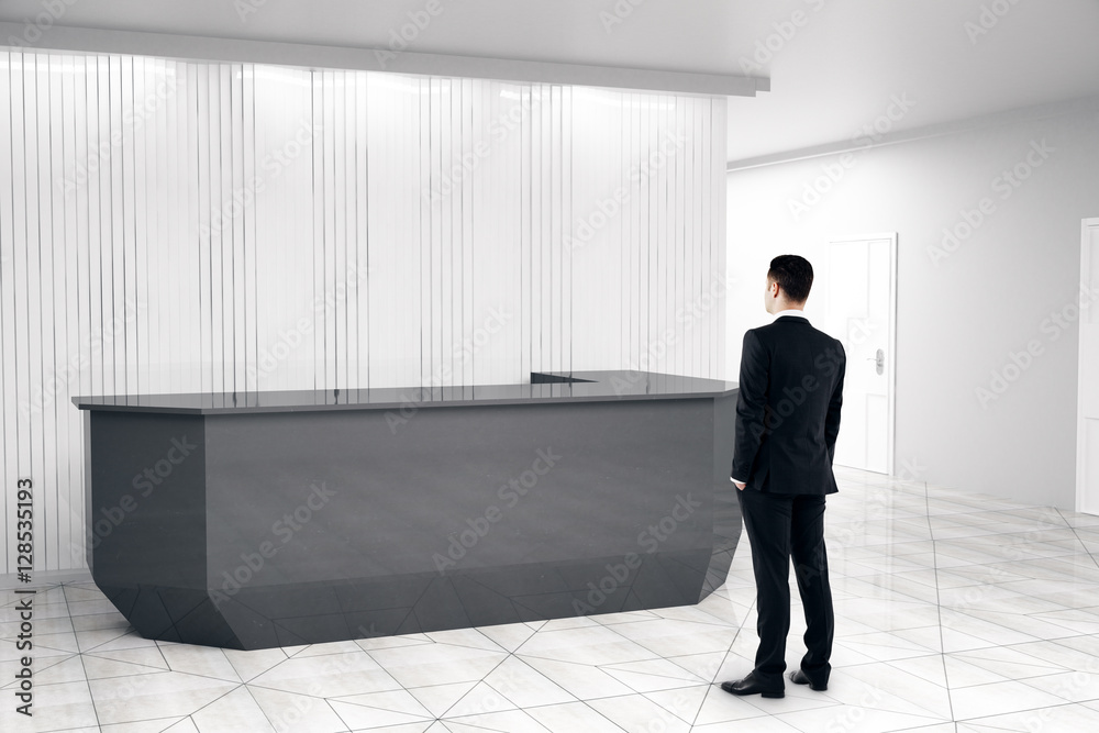 Man looking at reception desk