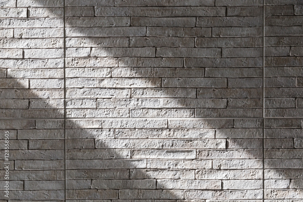 brick wall light color texture with direct light area from sunli