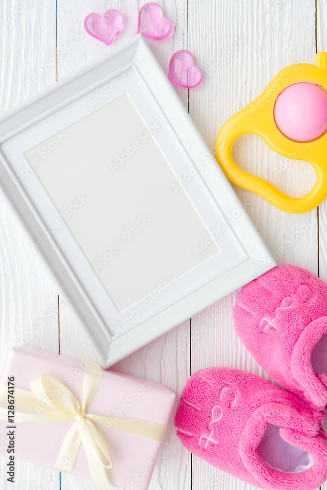 birth of child - blank picture frame on wooden background