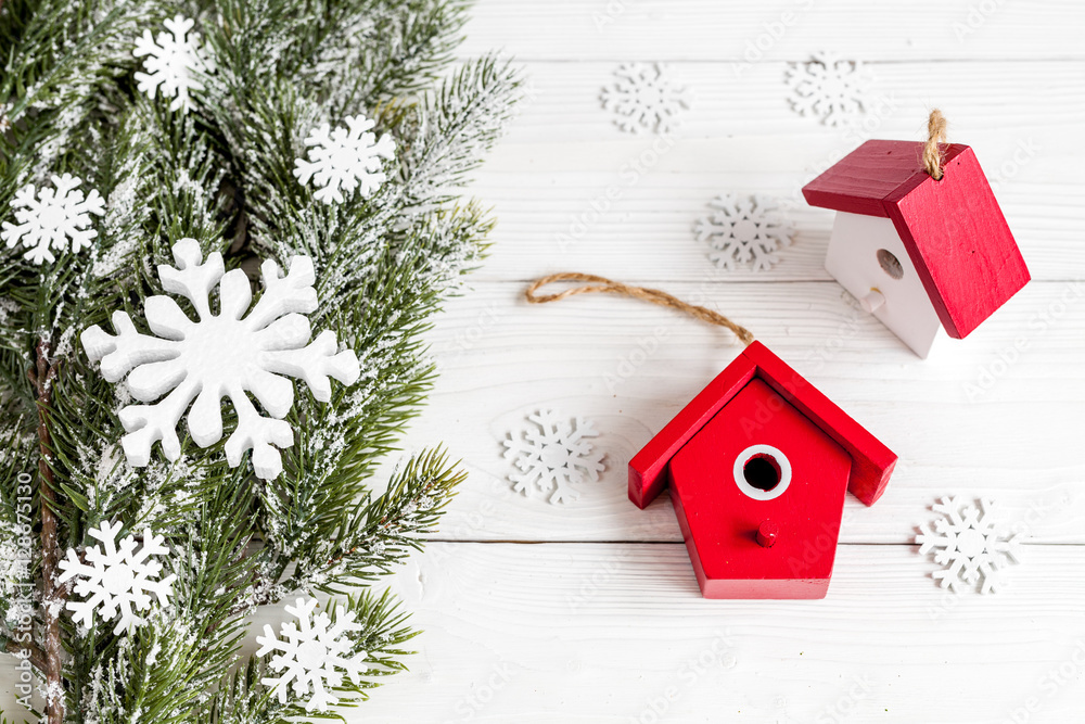 Christmas toys and spruce branches on wooden background top view