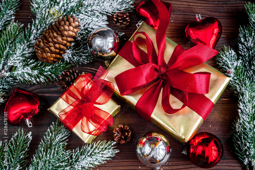 gifts boxes with fir branches on wooden background top view