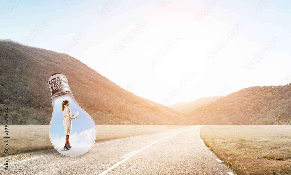 Businesswoman inside light bulb