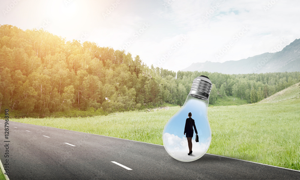 Businesswoman inside light bulb