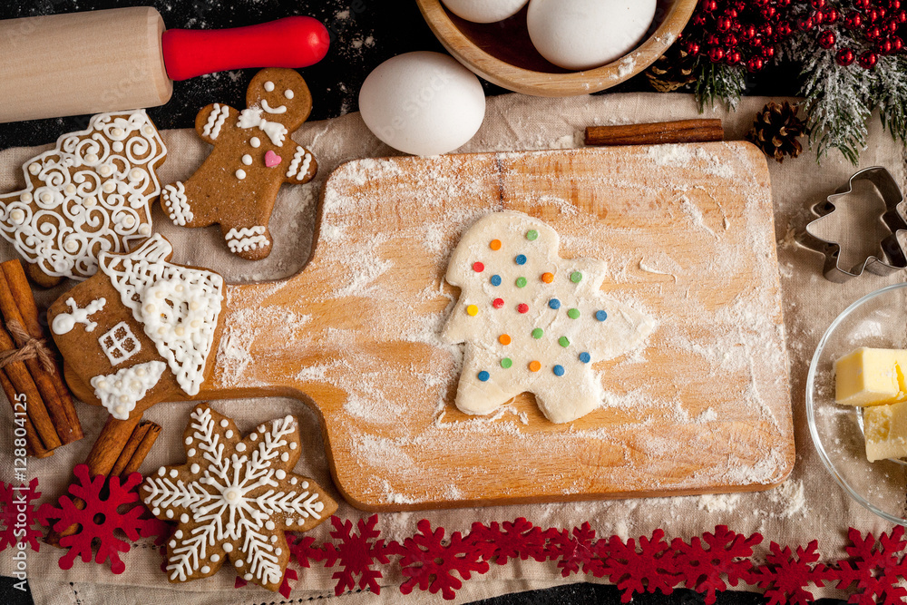 cooking christmas gingerbread on wooden background top view