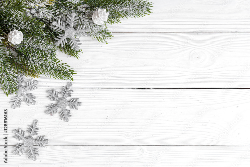 Christmas toys and spruce branches on wooden background top view