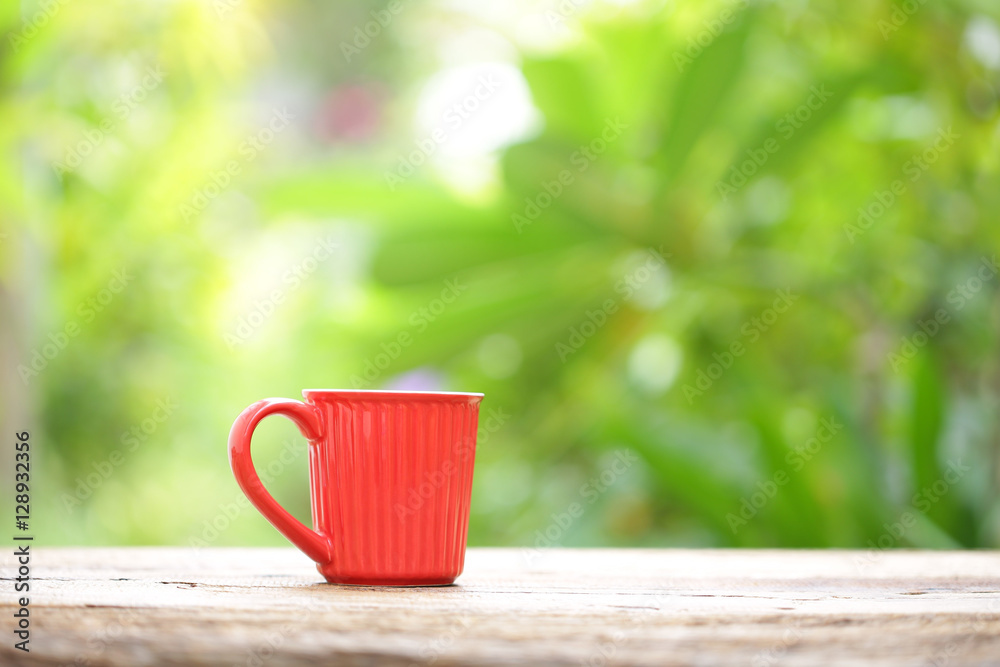 red coffee mug on wooden table 