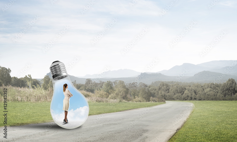 Businesswoman inside light bulb