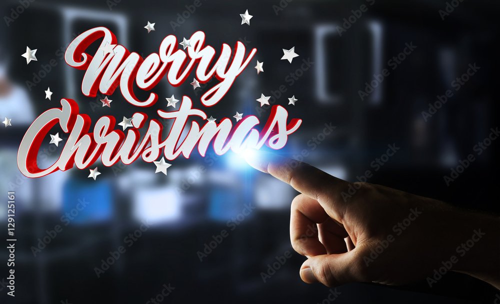 Businessman touching floating christmas message with his finger