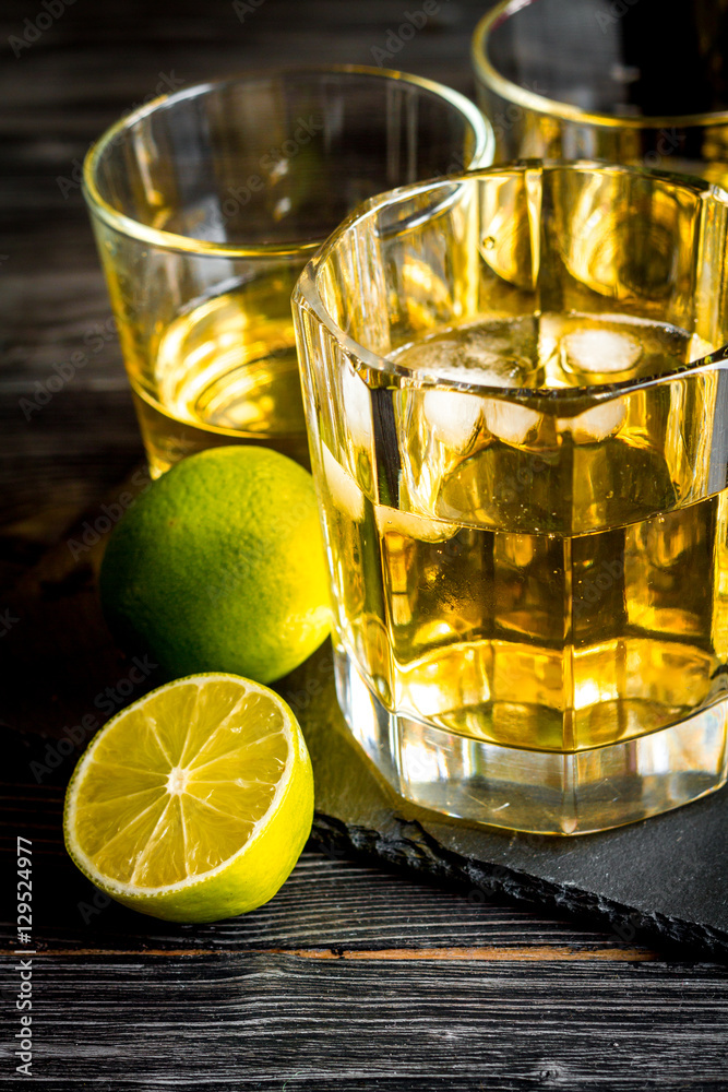 glass of whiskey on dark wooden background