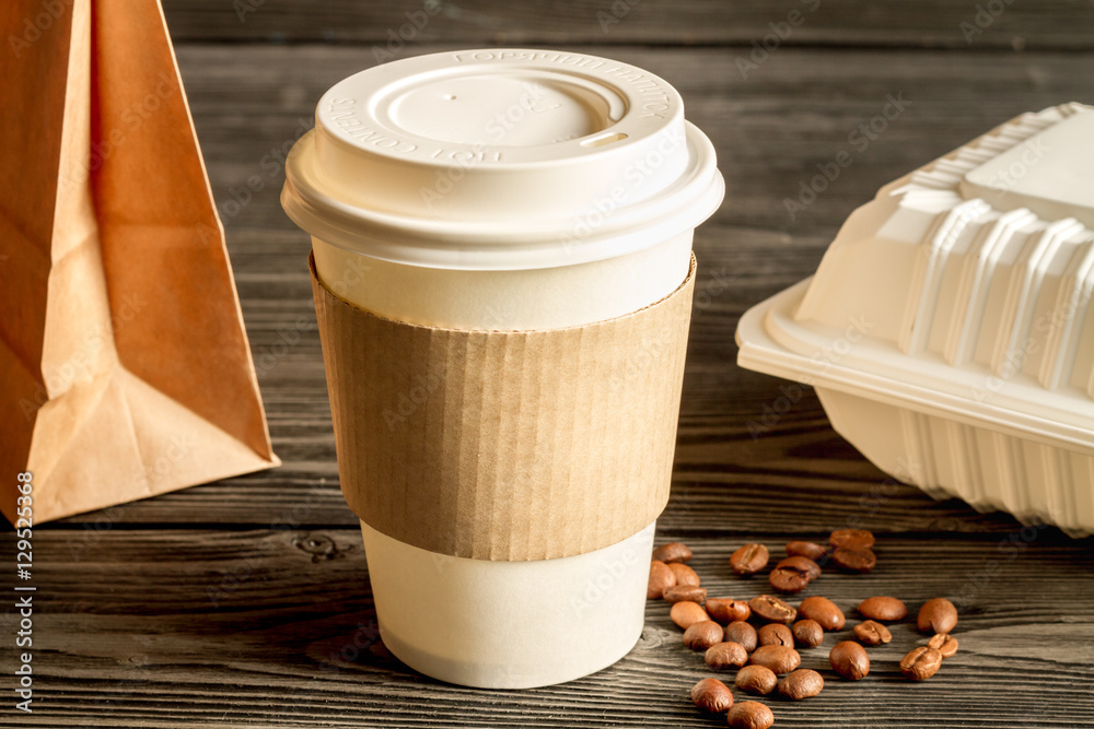 coffee cup to go at wooden background