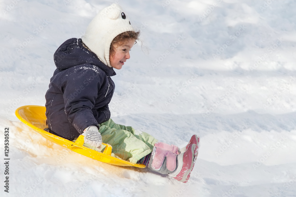 Girl sledging down hills winter