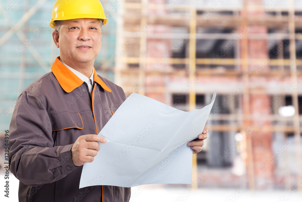 old asian man engineer with blueprint and new construction site