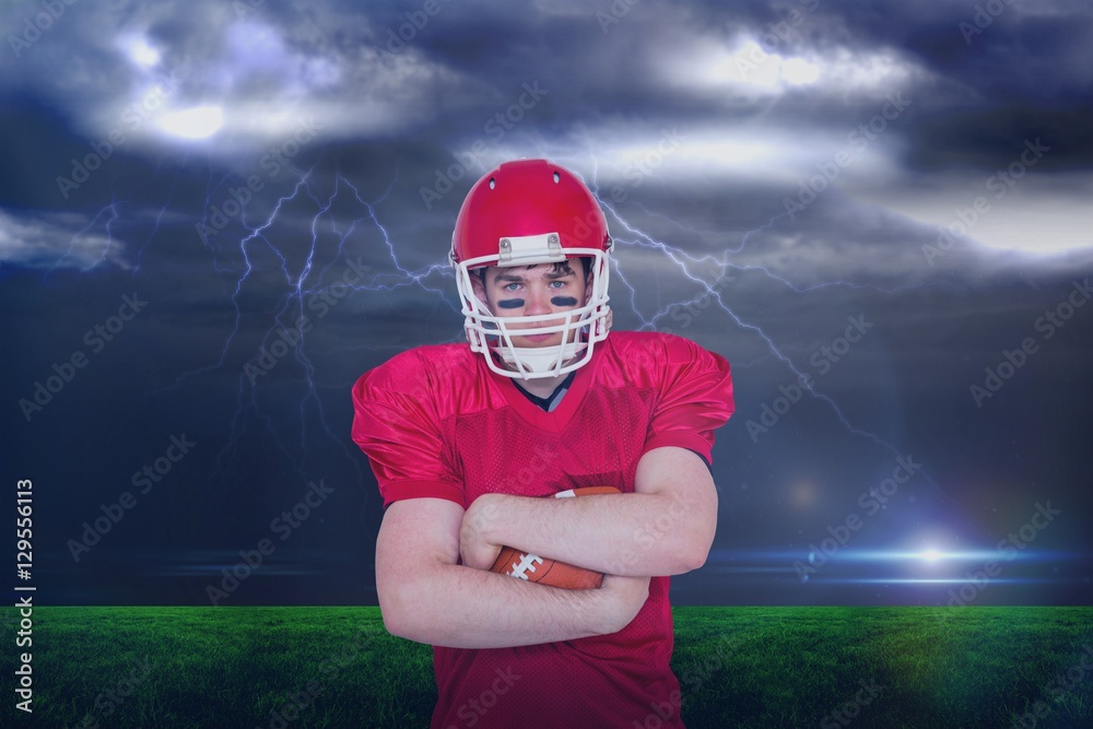 Composite image of american football player with arms crossed