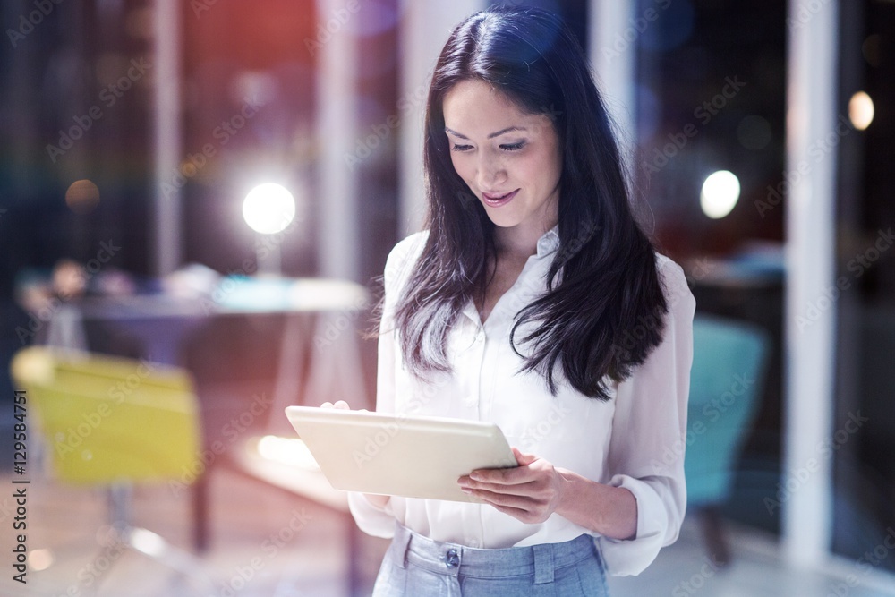 Smiling businesswoman using digital tablet