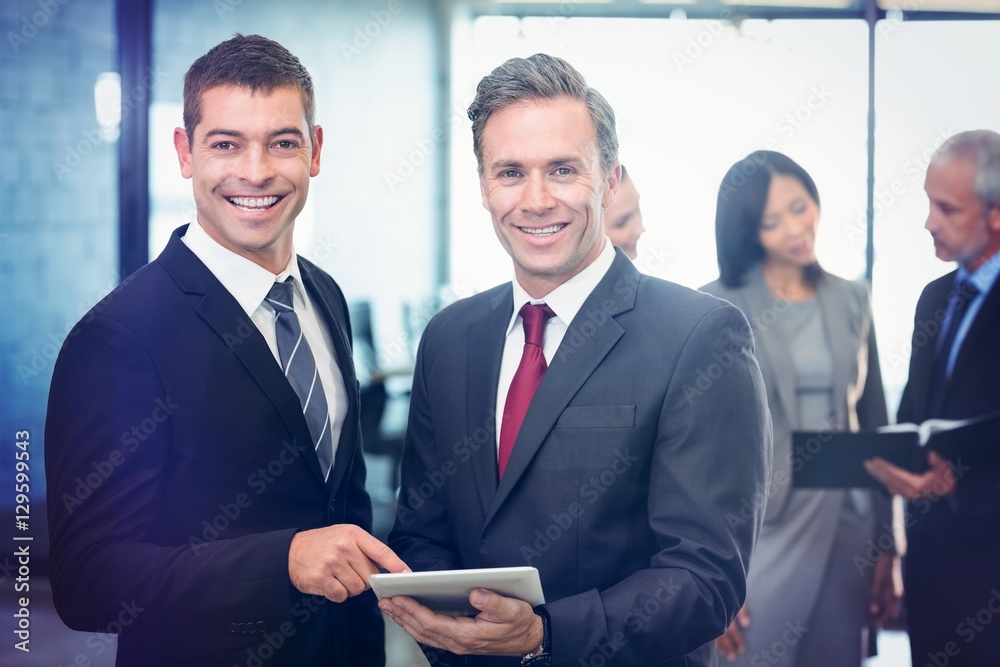 Portrait of businessmen using digital tablet