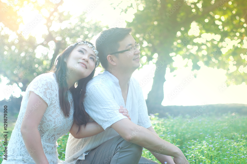 The asian couple embracing in the park