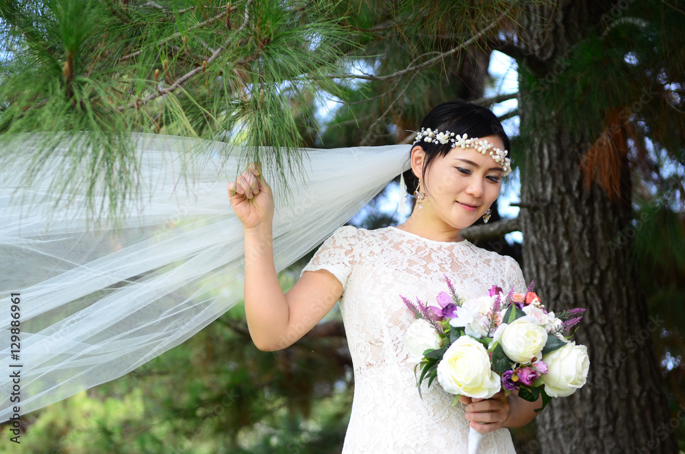 Outdoor portrait of a beautiful asian bride