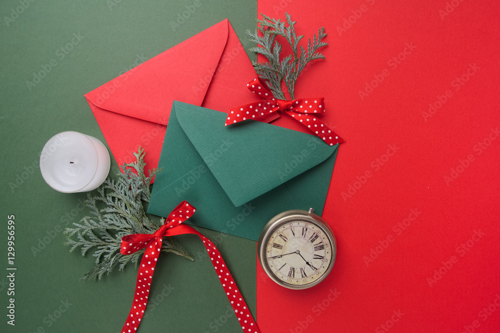 Red and green envelopes on christmas holiday background. Flat lay.