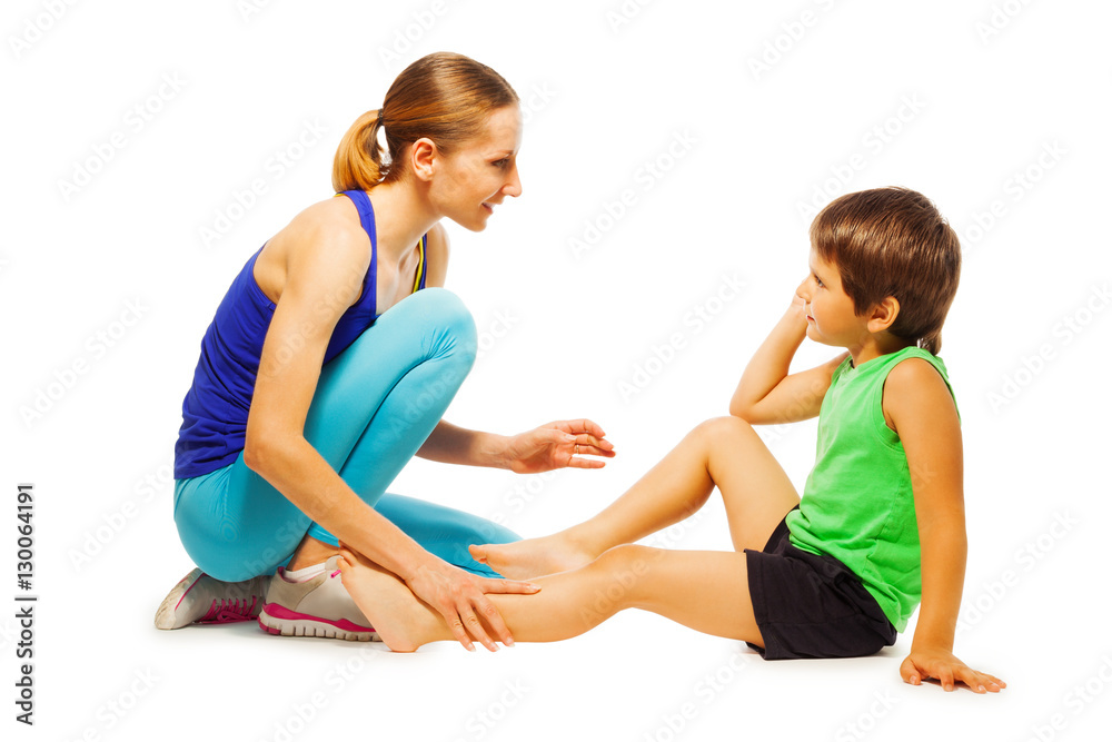 Young coach explaining how to do exercises for boy