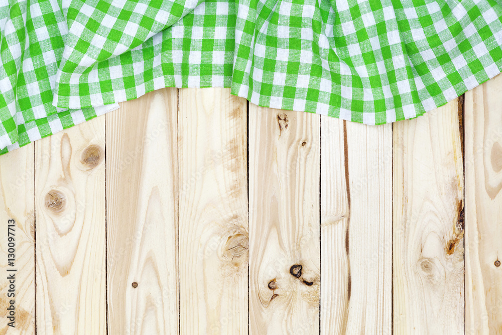 Wooden table, top view, green checkered tablecloth