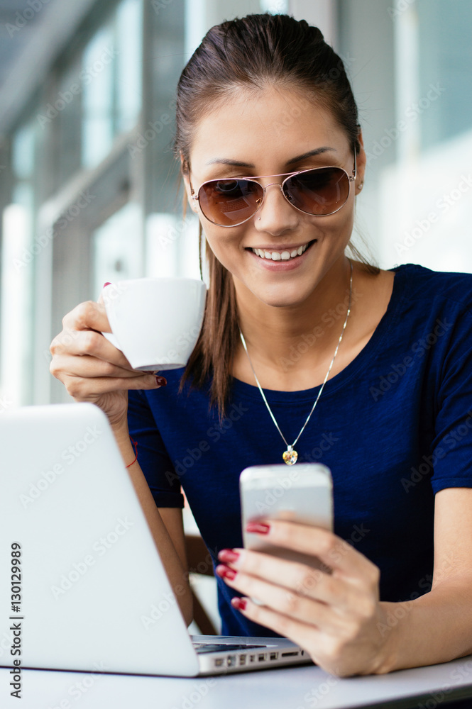 Young Woman with Coffee Cup on the Phone Out in the City - Woman