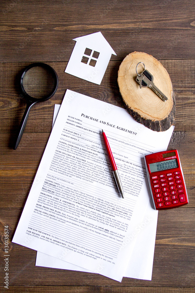 concept of buying house on wooden background top view