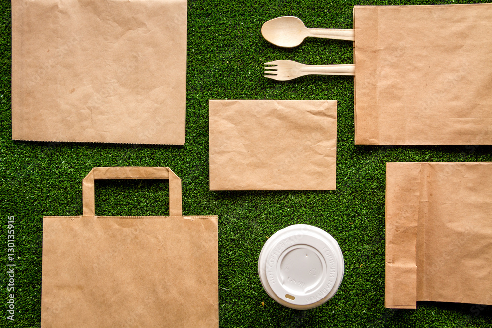 take out in paper bag on green background top view