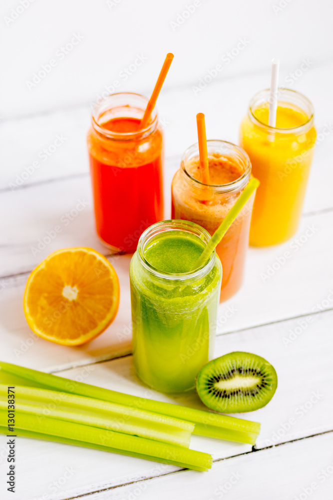 Fresh detox juices in glass bottles on white background