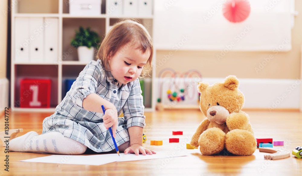 Happy toddler girl playing with toys