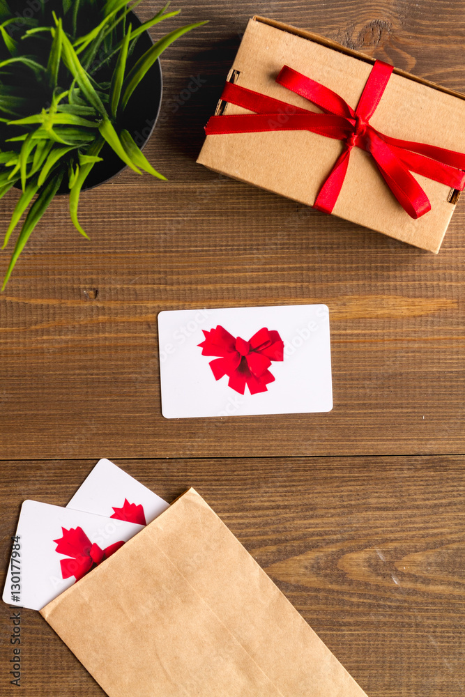 concept of gift cards on wooden background top view