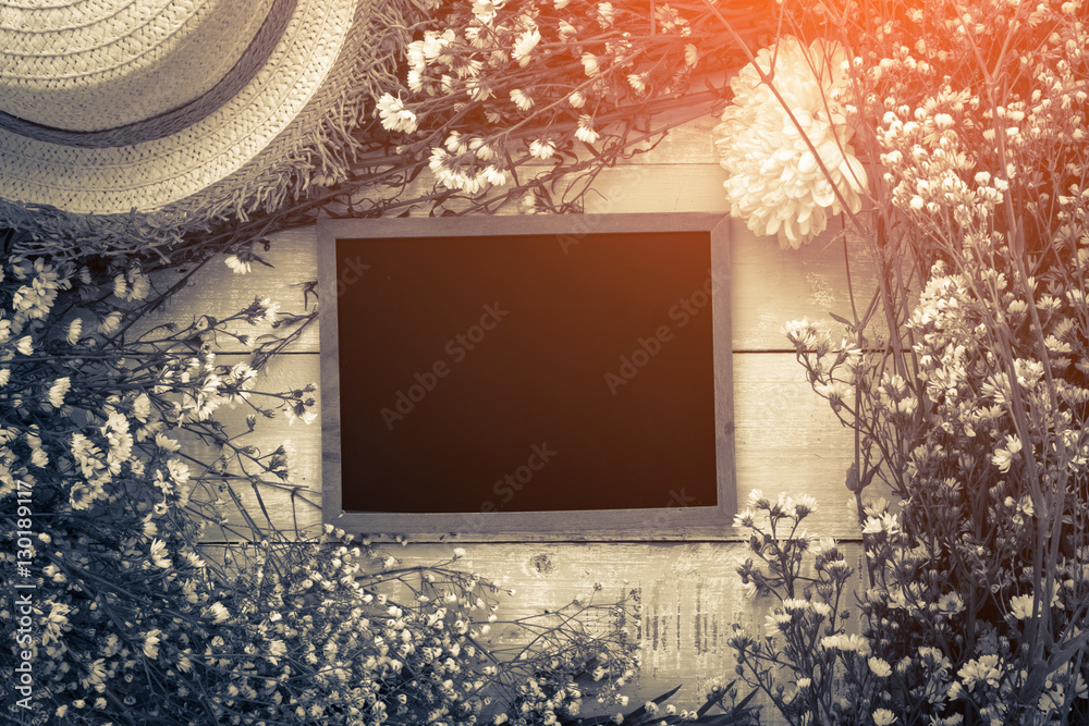 Beautiful blossom branch with framed blackboard over wooden back