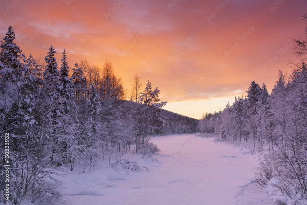 Sunrise over a river in winter near Levi, Finnish Lapland